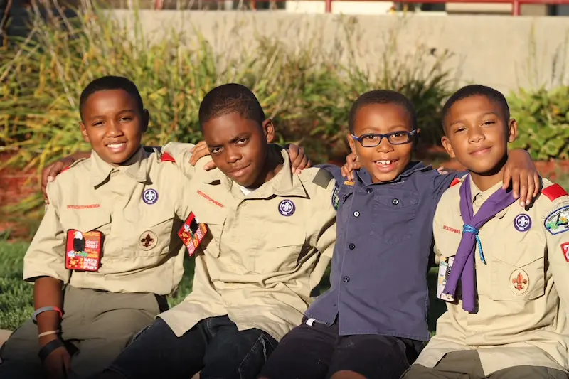 An image of Boy Scouts shoulder to shoulder smiling