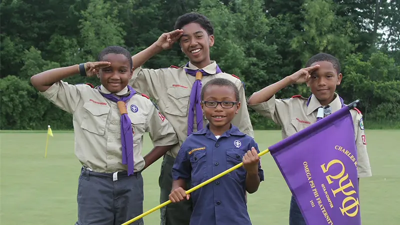 Group Of Scouts Saluting Holding Flag